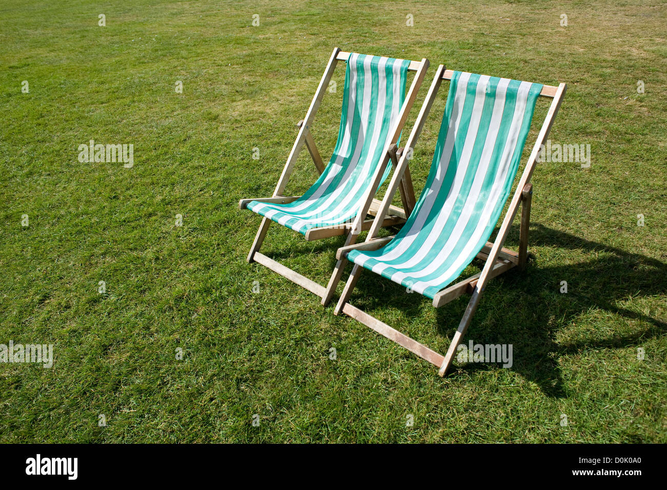 Two deck chairs in Hyde Park Stock Photo - Alamy