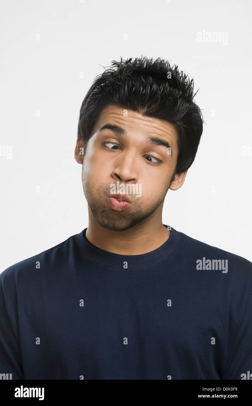 Close-up of a man making a face with puffed cheeks Stock Photo