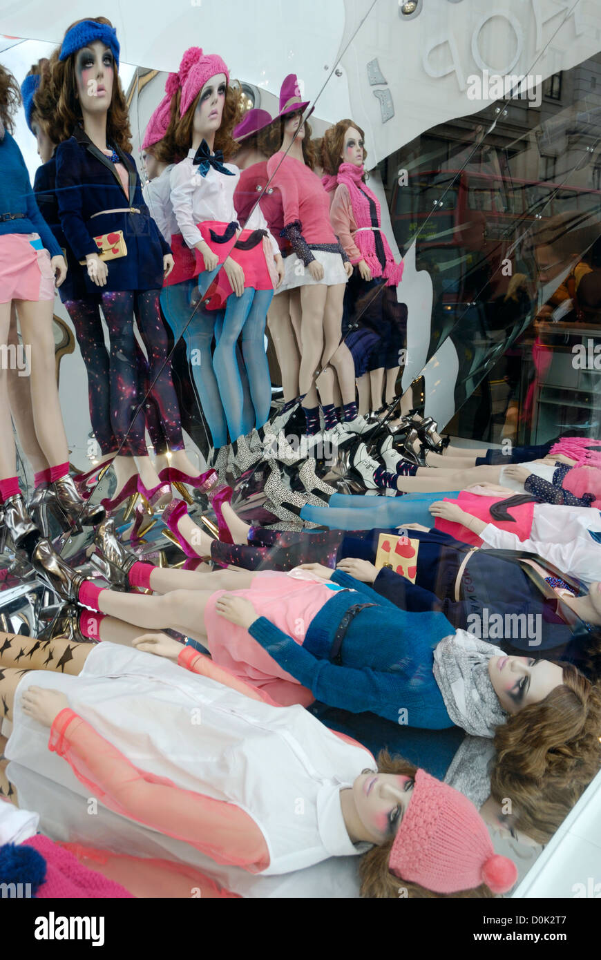 A fashion shop window display consisting of mannequins reflected in a mirror. Stock Photo