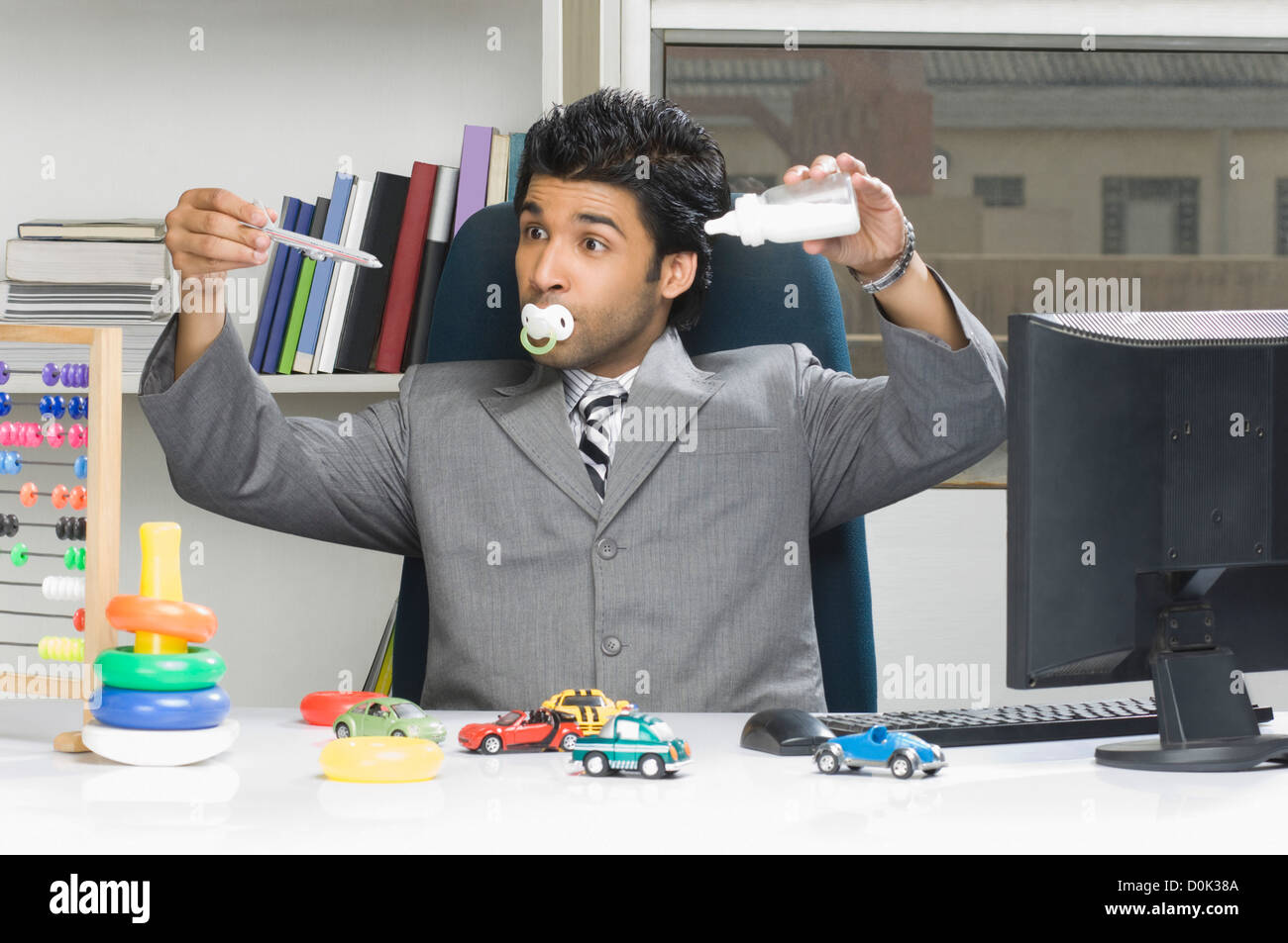 Businessman behaving like a kid in an office Stock Photo