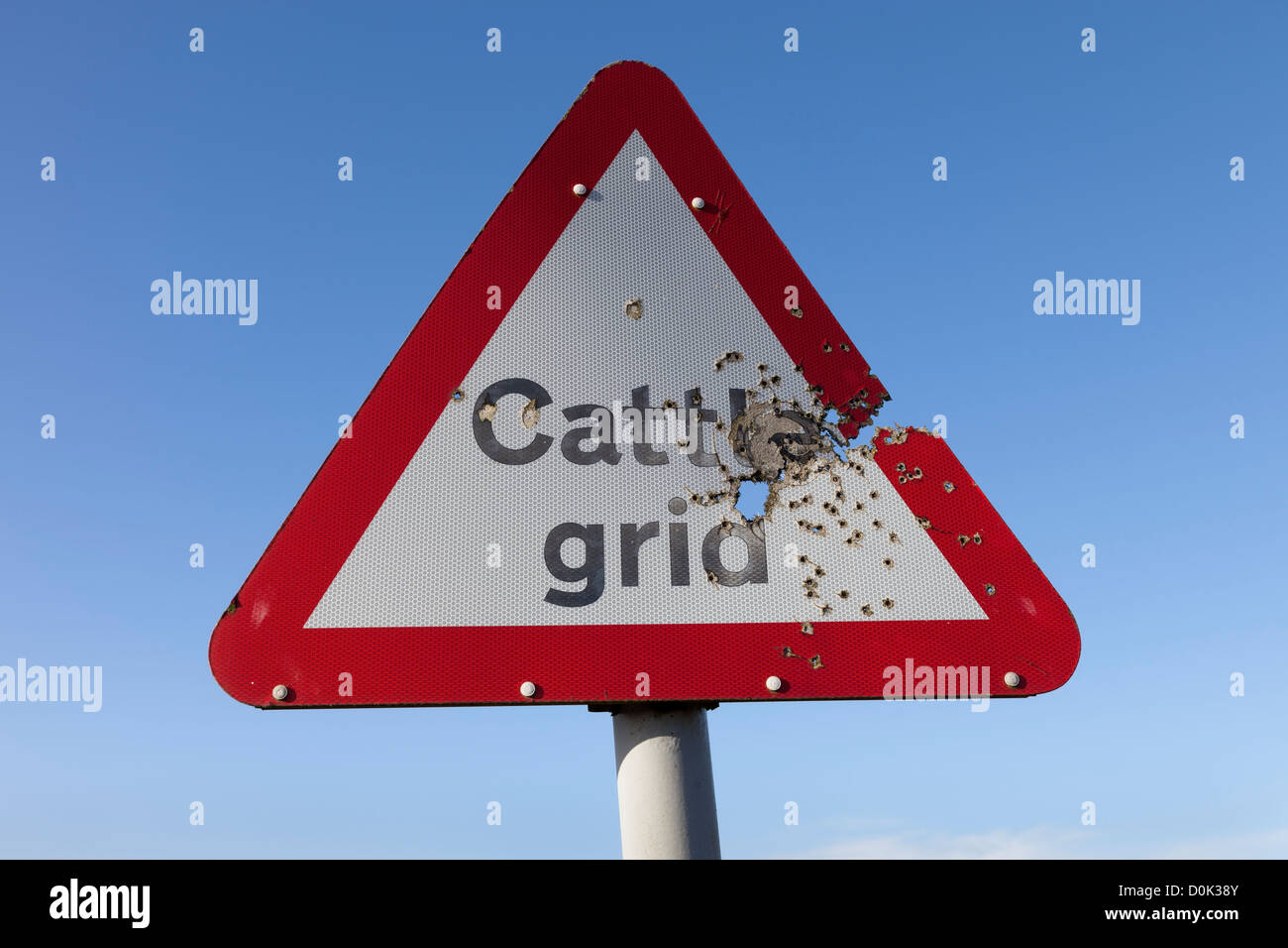 Cattle Grid Road Sign Damaged by Shotgun Pellets UK Stock Photo