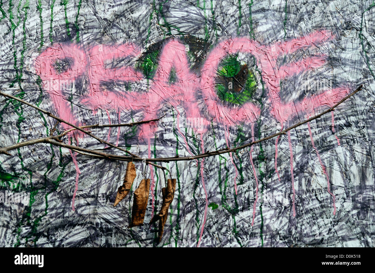 The word Peace written over wall graffiti. Stock Photo