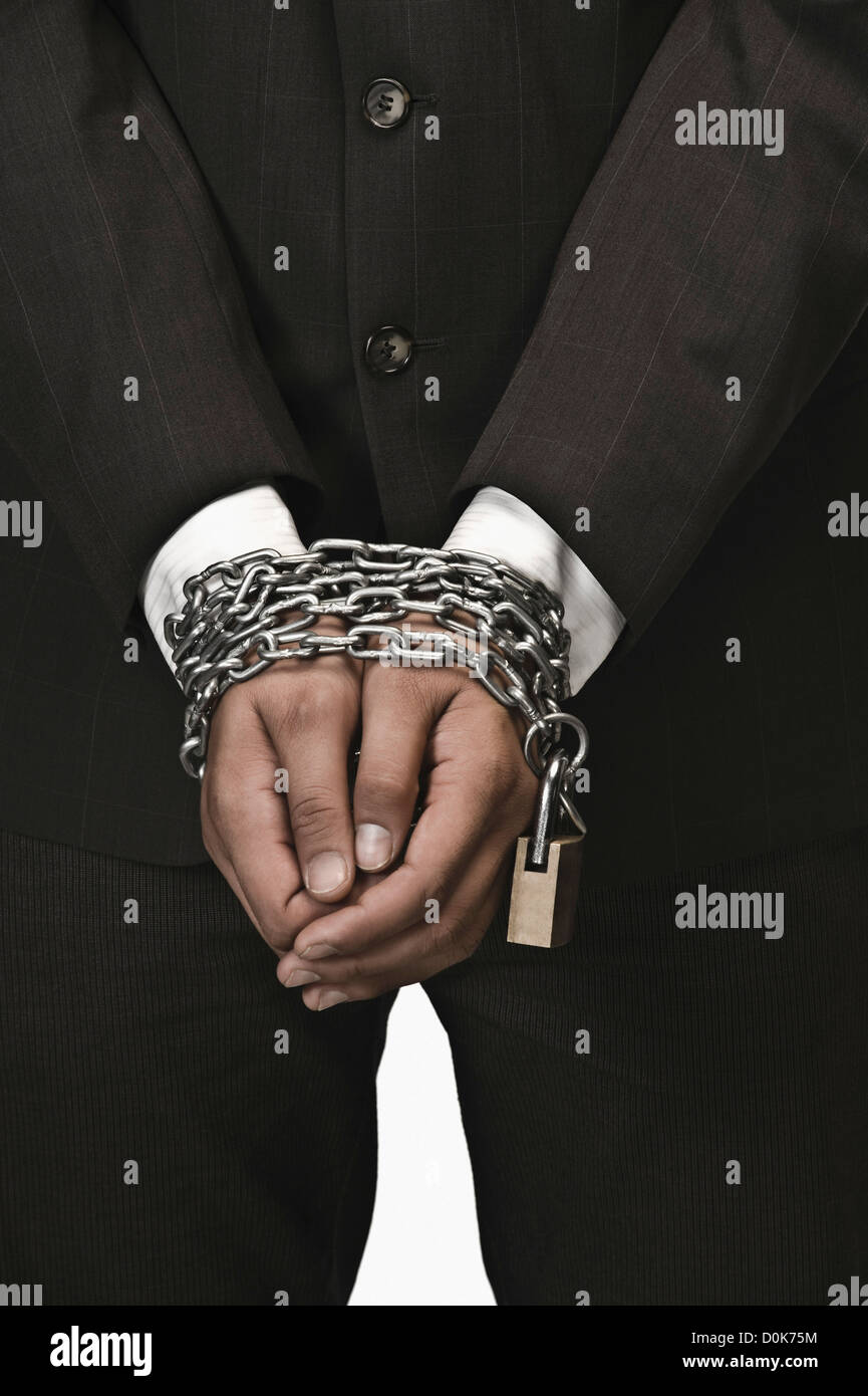 Closeup of a businessman's hands locked with chains Stock Photo Alamy