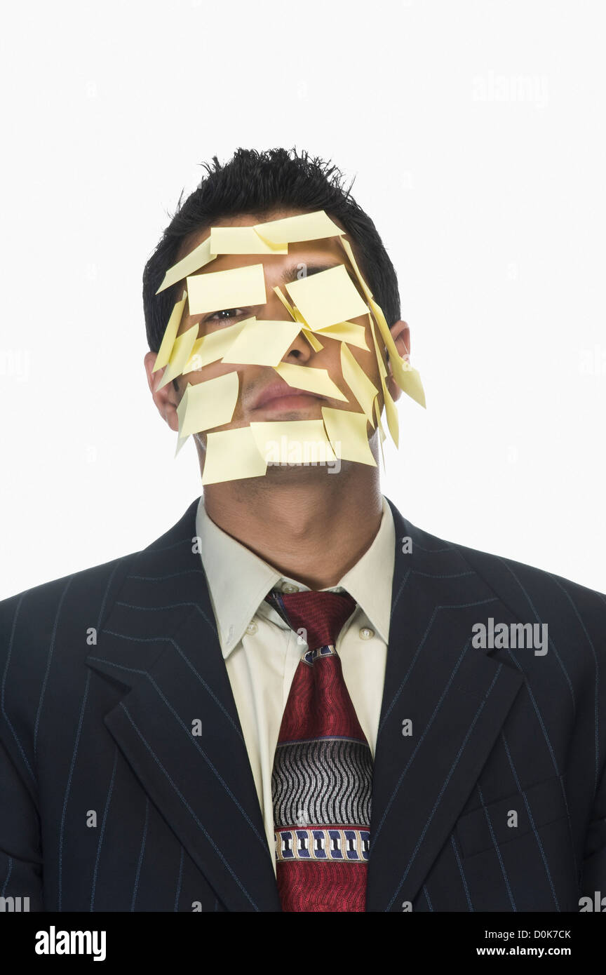 Businessman's face wrapped with adhesive notes Stock Photo Alamy
