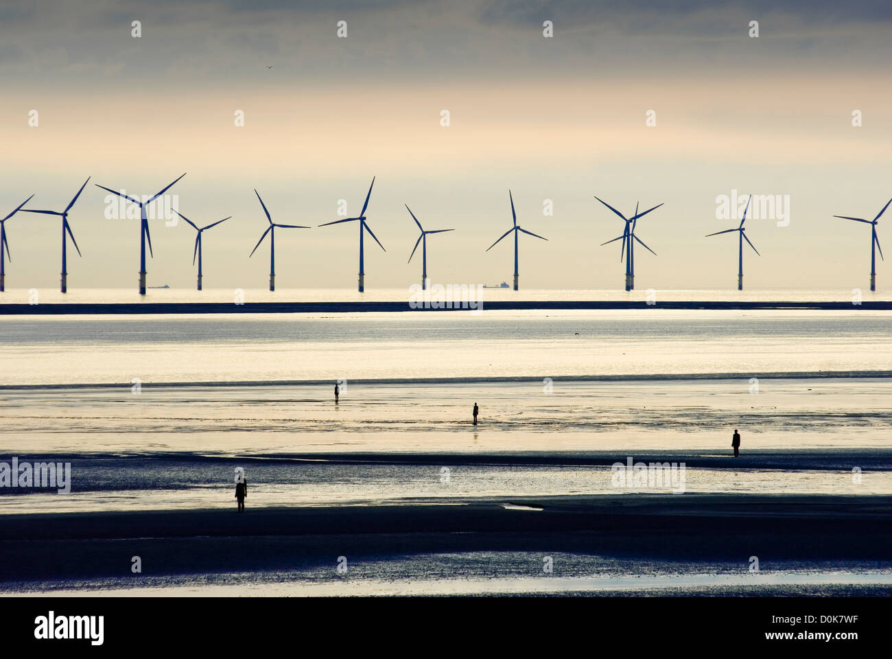 Sculptures and wind turbines on a Liverpool beach Stock Photo Alamy