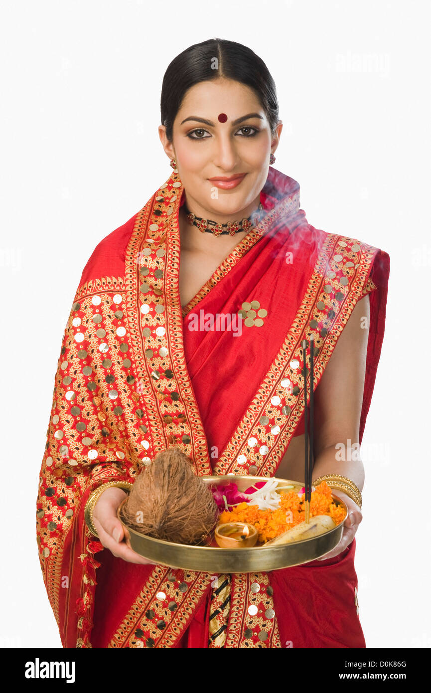 Woman in traditional Assamese mekhla holding religious offering Stock