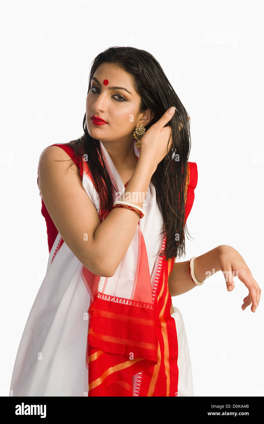 Woman in traditional Bengali saree with her hand in her hair Stock ...