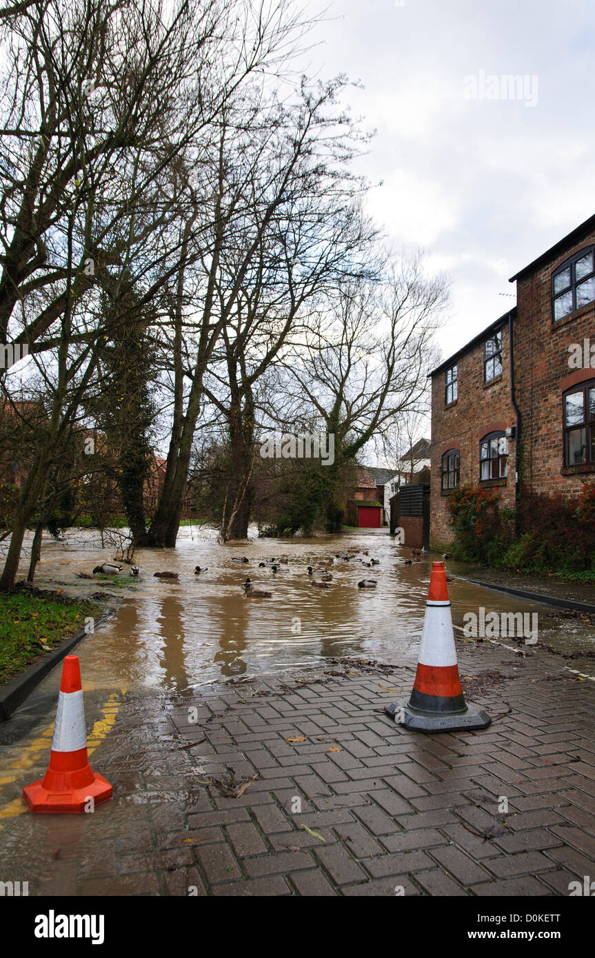 Heavy rain has brought flooding to many parts of the UK with North Yorkshire being particularly badly hit.  This picture shows a road closed and coned off due to flood waters from Cod Beck which has burst its banks as it flows through the market town of Thirsk, North Yorkshire on 27th November 2012. Stock Photo