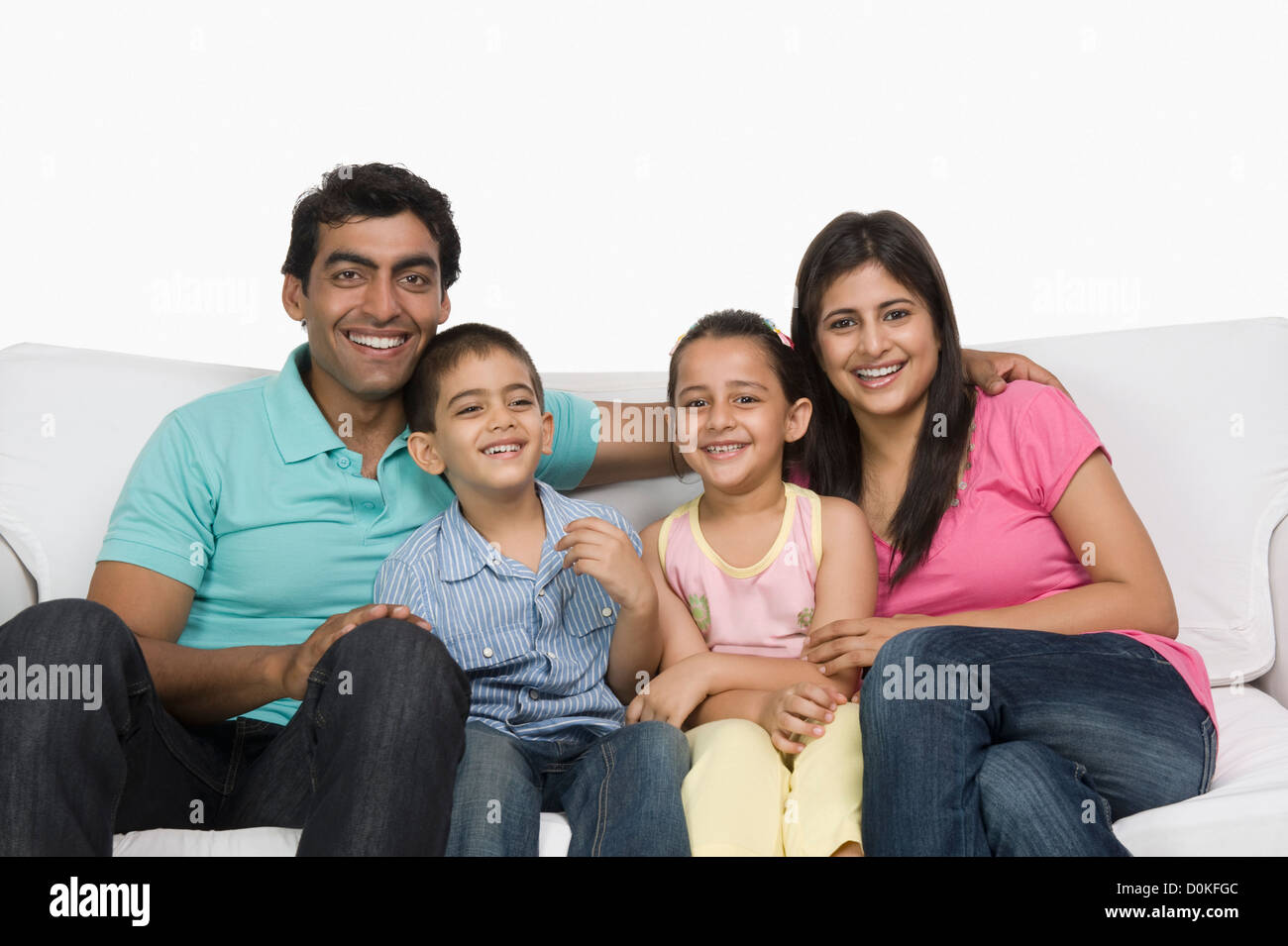 Portrait of a family sitting on a couch Stock Photo - Alamy