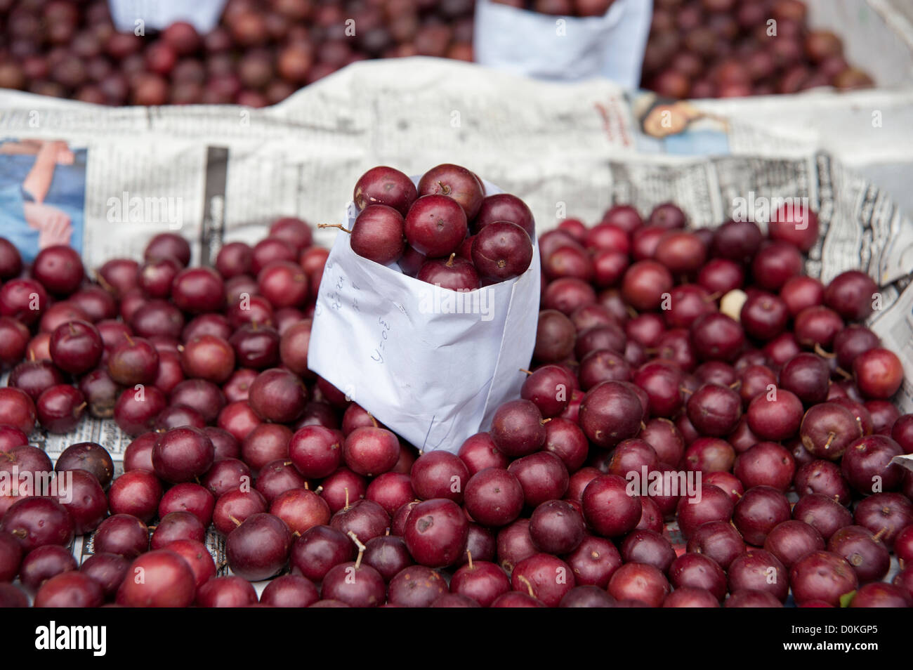 A close up of a mound of red cherries for sale in market Kandy Sri