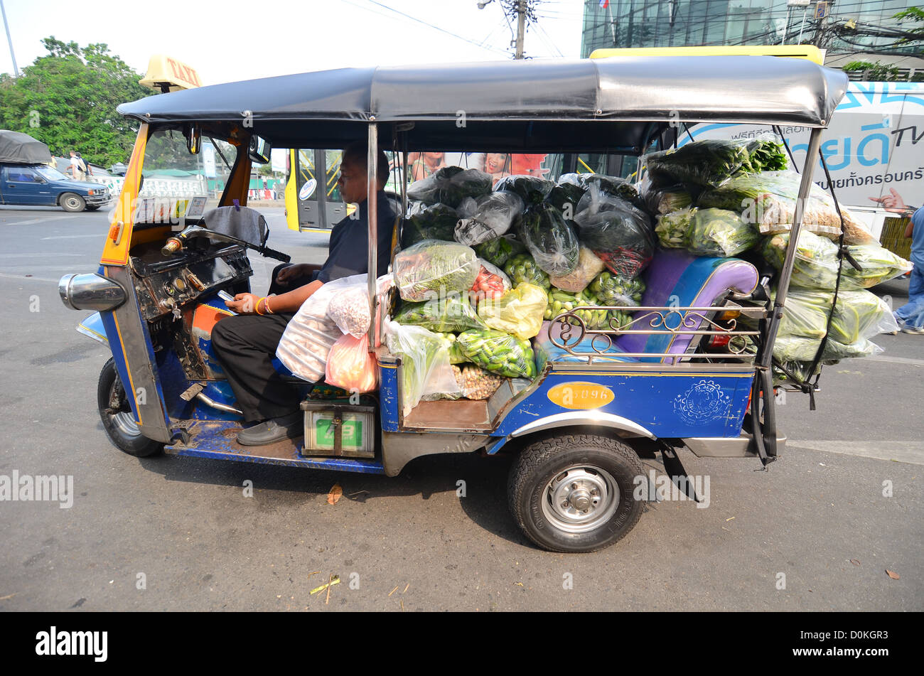A tuk-tuk in Bangkok loaded with vegetables. Stock Photo