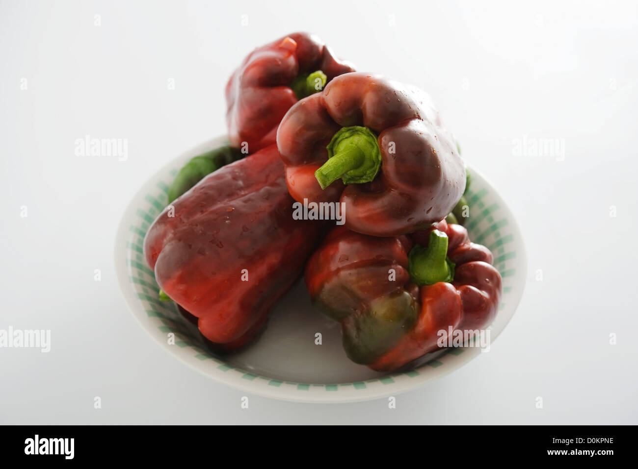 Red and green peppers on white background Stock Photo - Alamy