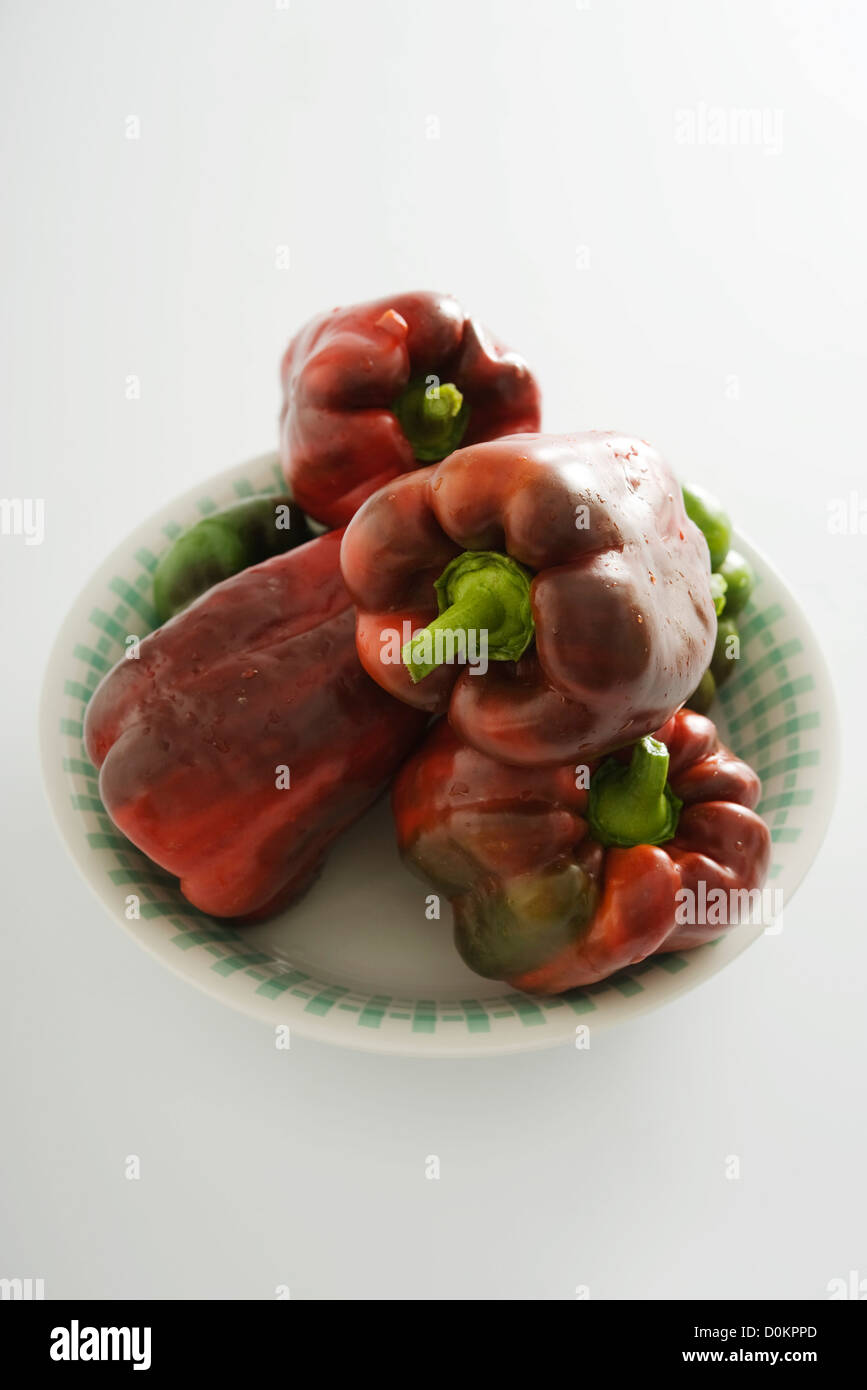 Red and green peppers on white background Stock Photo - Alamy