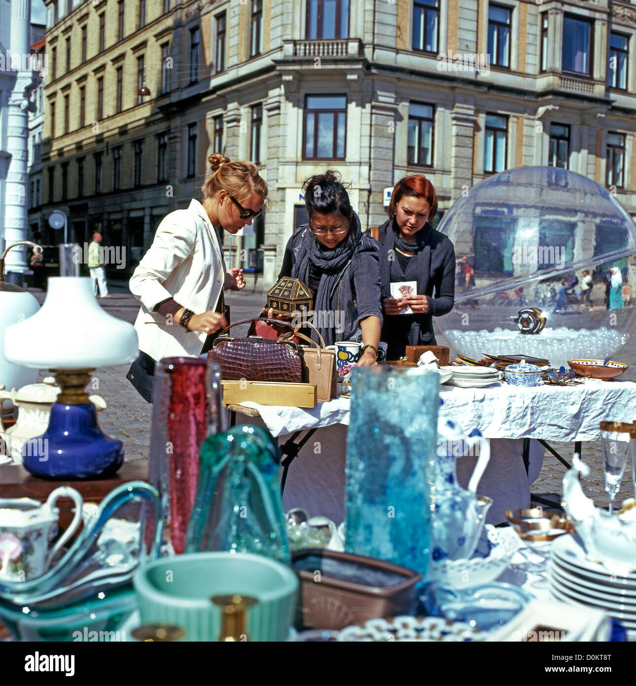 Young women shopping at an antiques stall in an outdoor Copenhagen