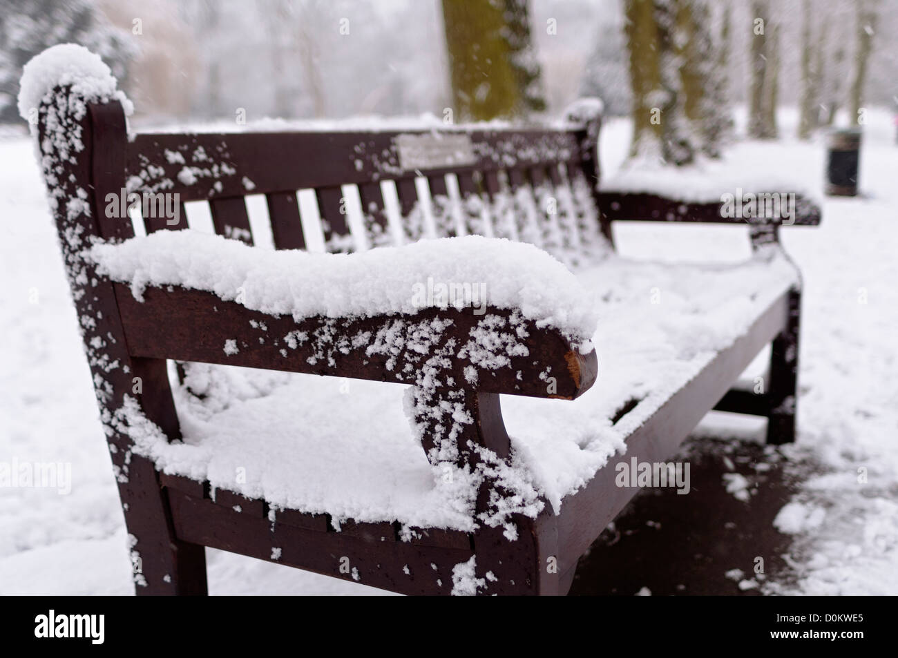 A snow-covered bench in Waterlow Park in North London. Stock Photo
