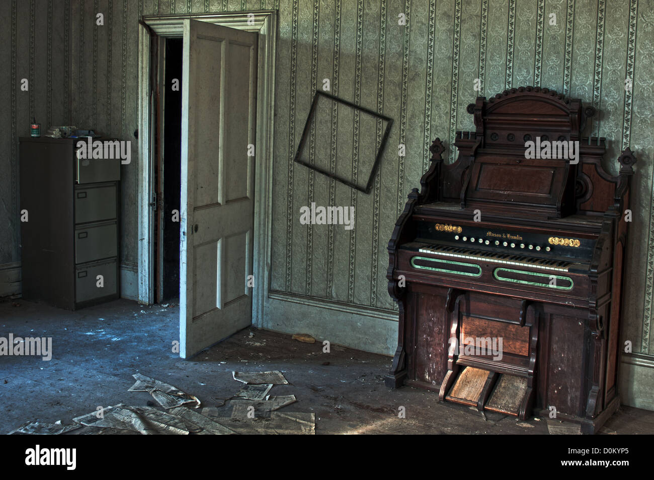 An Old Mason and Hamlin organ that was left behind in a derelict manor house Stock Photo