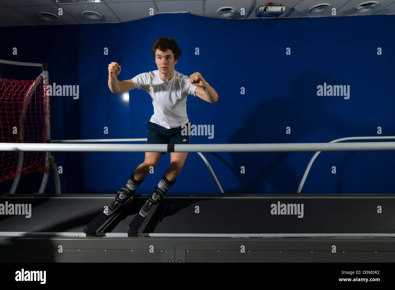 Athlete working out on interactive ski simulator at the gym Stock Photo
