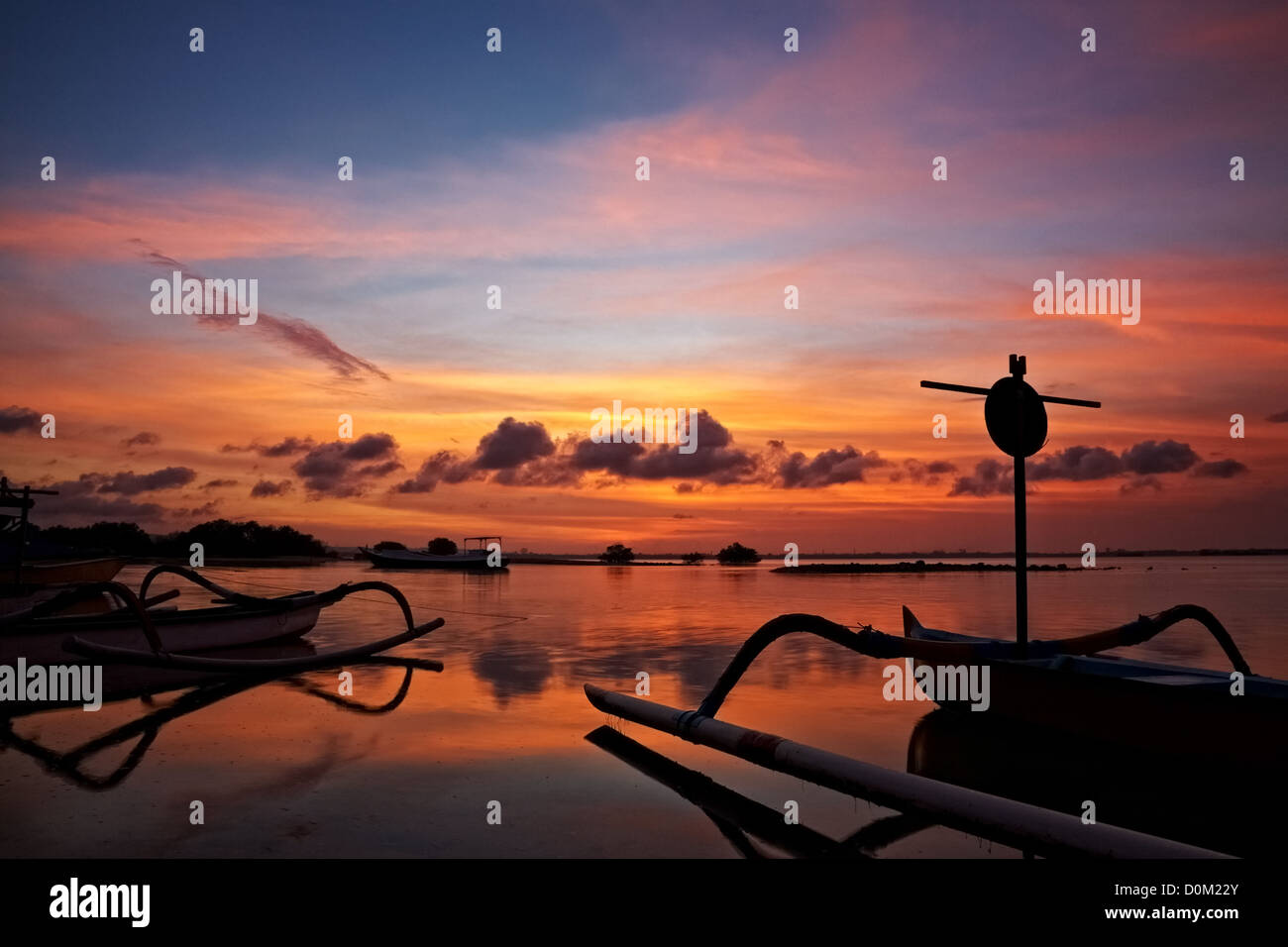 sunset over traditional fishing boats on Bali, Indonesia Stock Photo