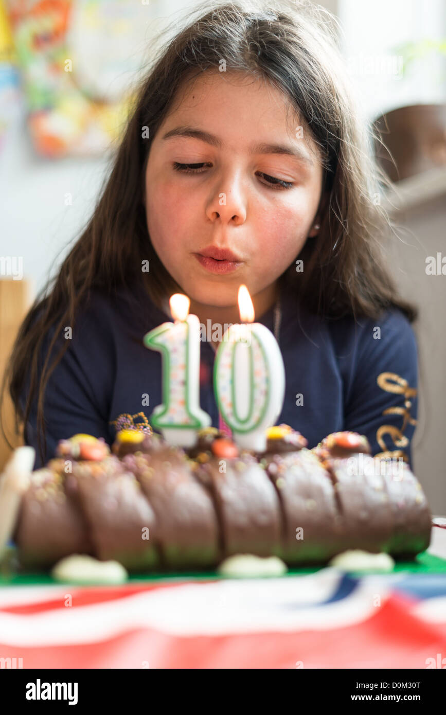 Girl blowing birthday candles Stock Photo Alamy