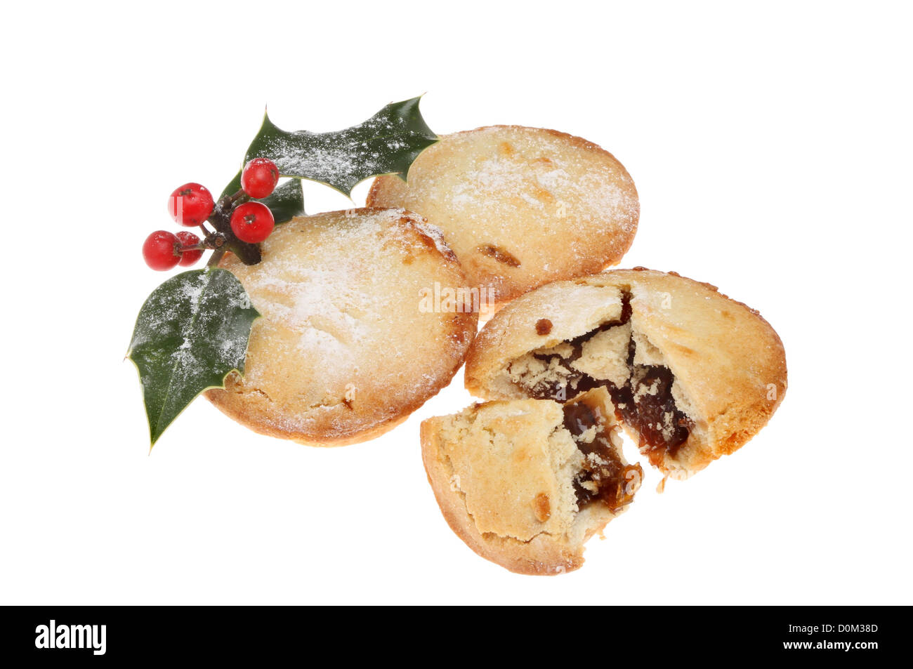 Group of mince pies dusted with icing sugar and decorated with a holly ...