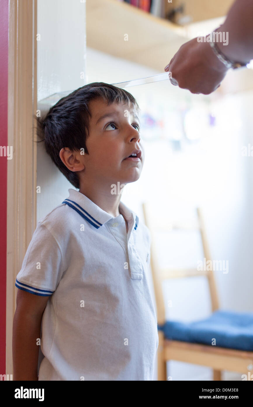 parent measures child's hight Stock Photo