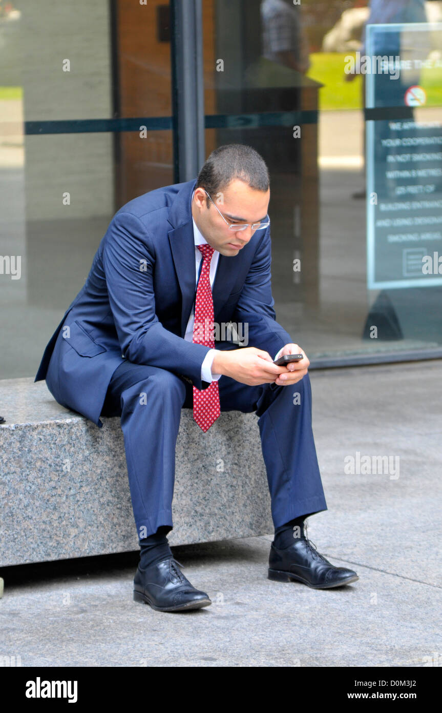 Professional male texting on cell smart phone Stock Photo