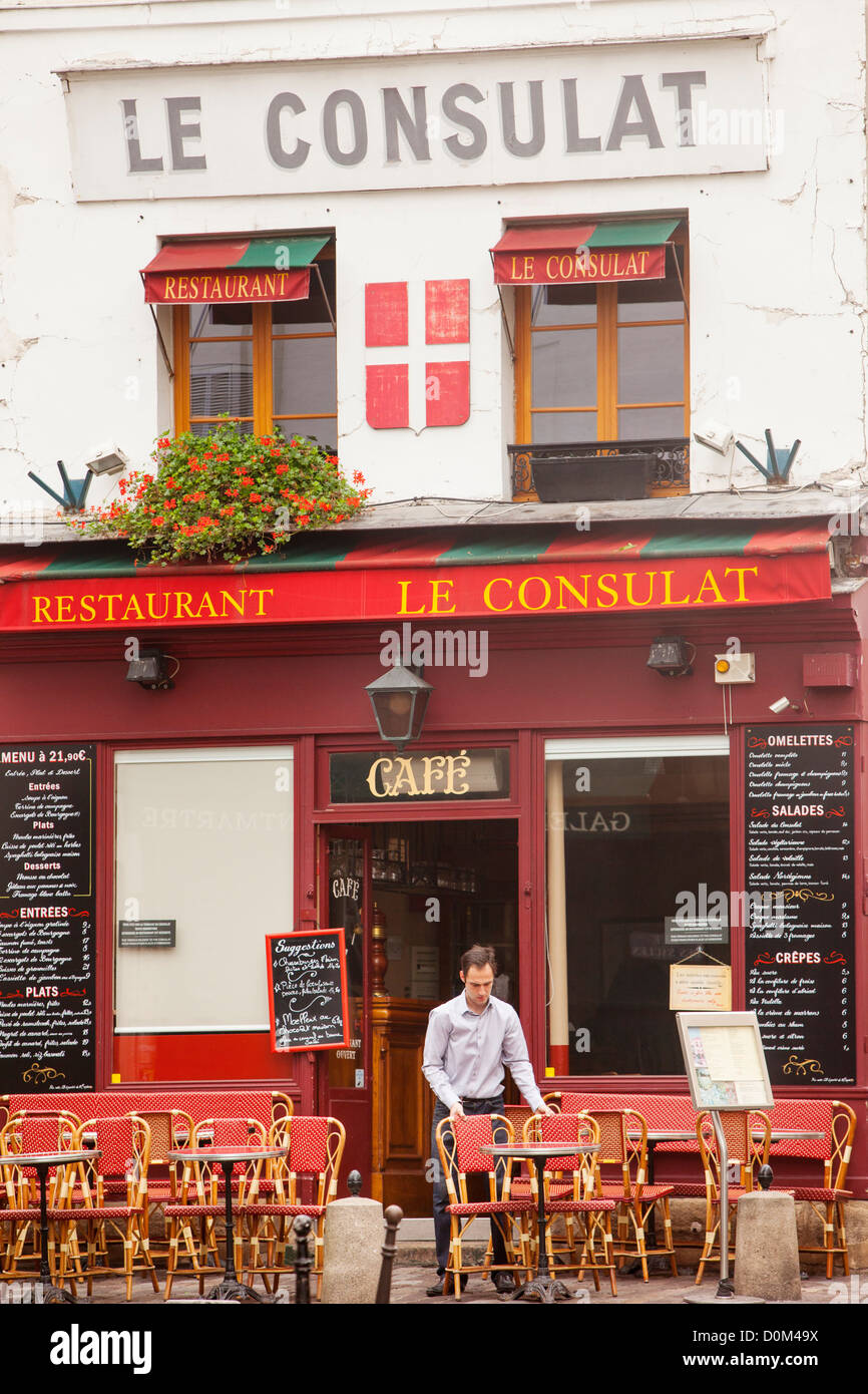 Man setting up for morning business at le Consulat - a well-known cafe in Montmartre, Paris France Stock Photo