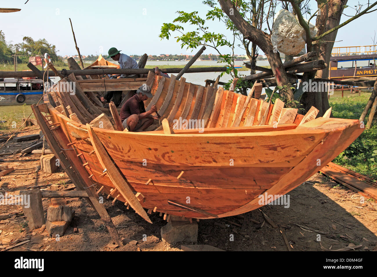 Boat builder on Cam Nam Island, Hoi An, Vietnam Stock Photo