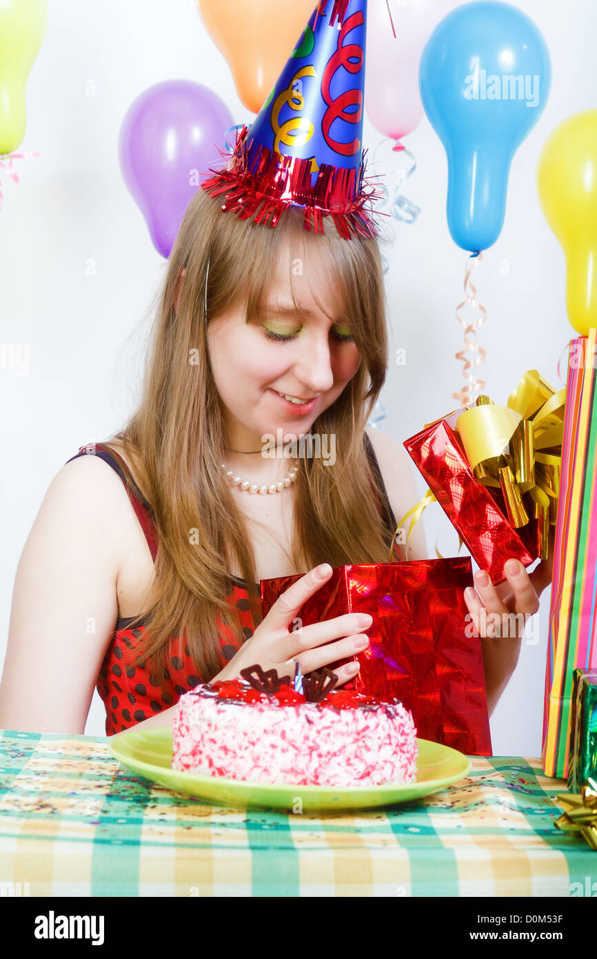 Birthday of a young girl. Opening the gifts Stock Photo