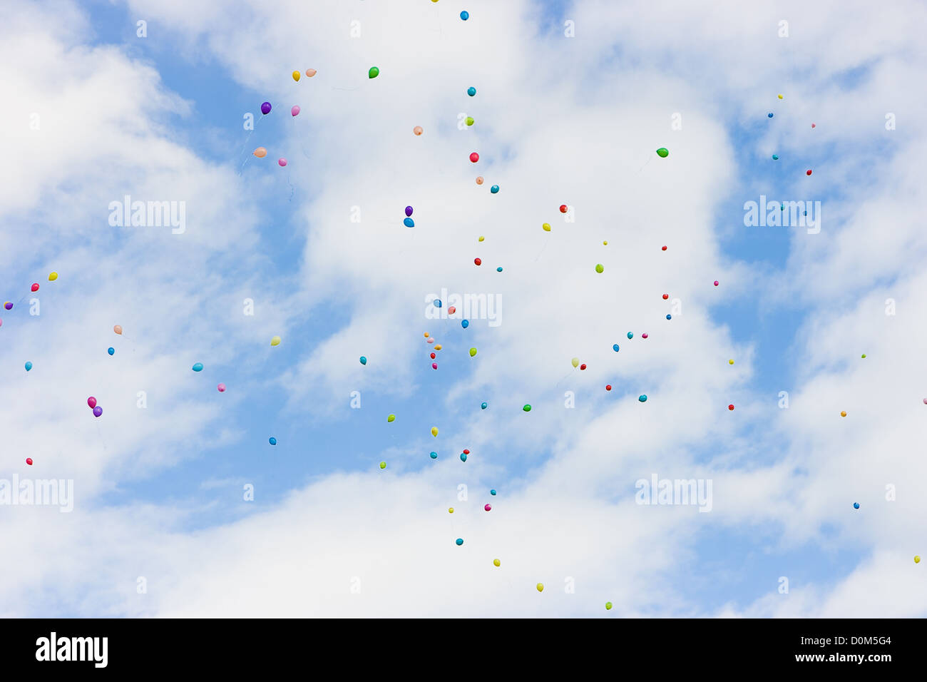 many colorful balloons high in the blue sky with white clouds Stock ...