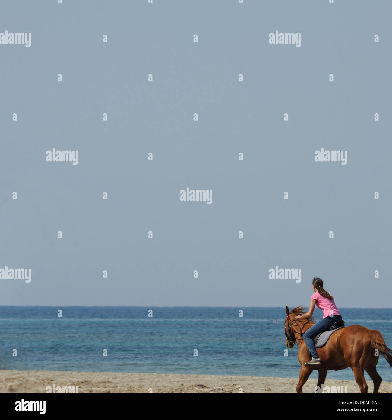 Young woman horse riding on empty beach, Kyllini Greece, May 2, 2012. Stock Photo