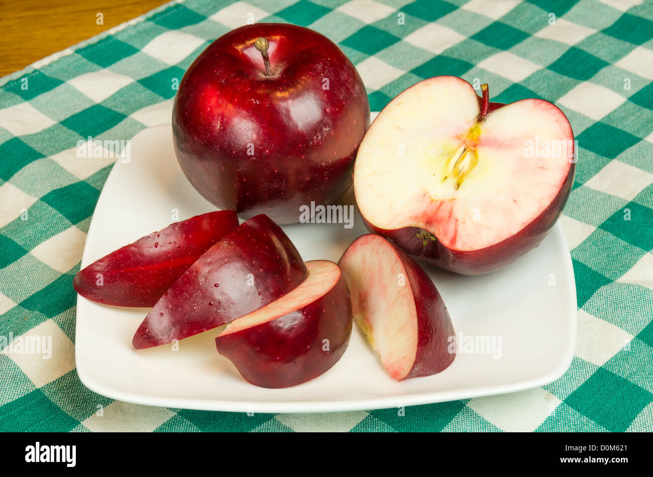 Rome Beauty apple sliced on white plate Stock Photo