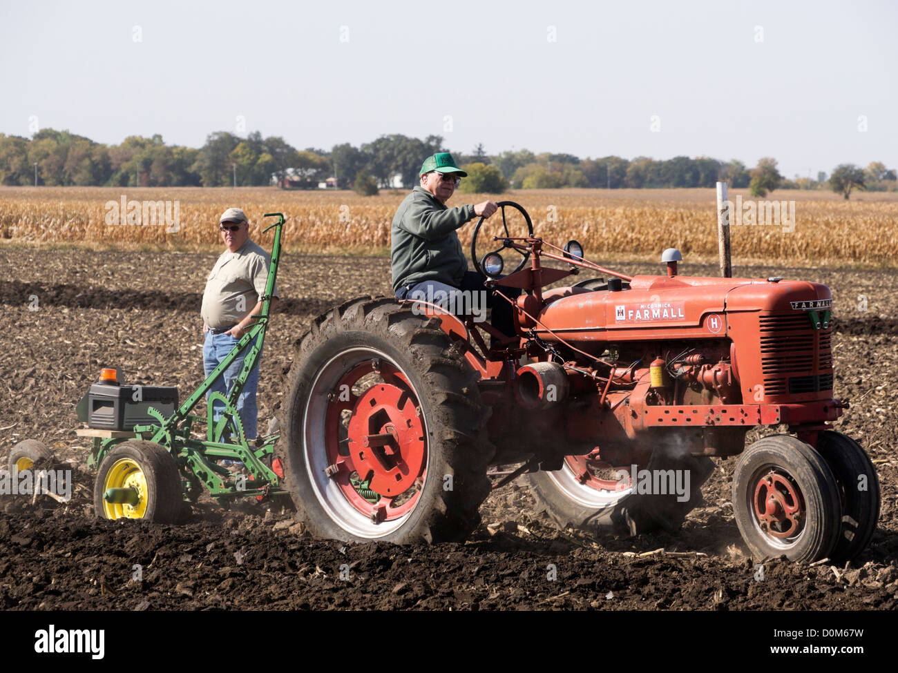 Farmall Model H plowing a field on a farm near Hebron, Illinois during an antique tractor plowing demonstration. Stock Photo
