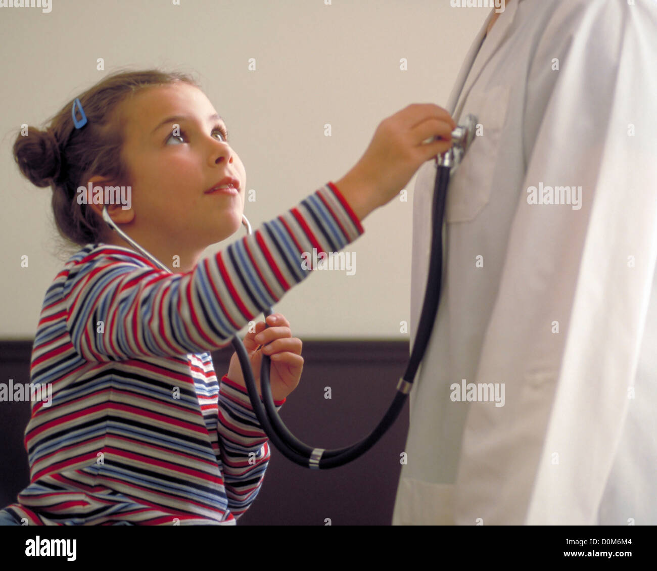 Pediatrician listening heartbeat girl stethoscope hi-res stock