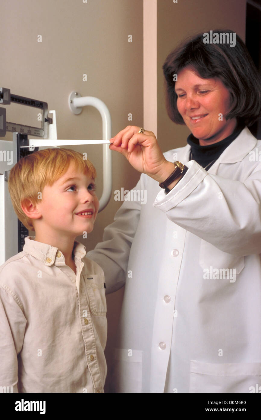 Pediatrician Measures Young Boy's Height Stock Photo