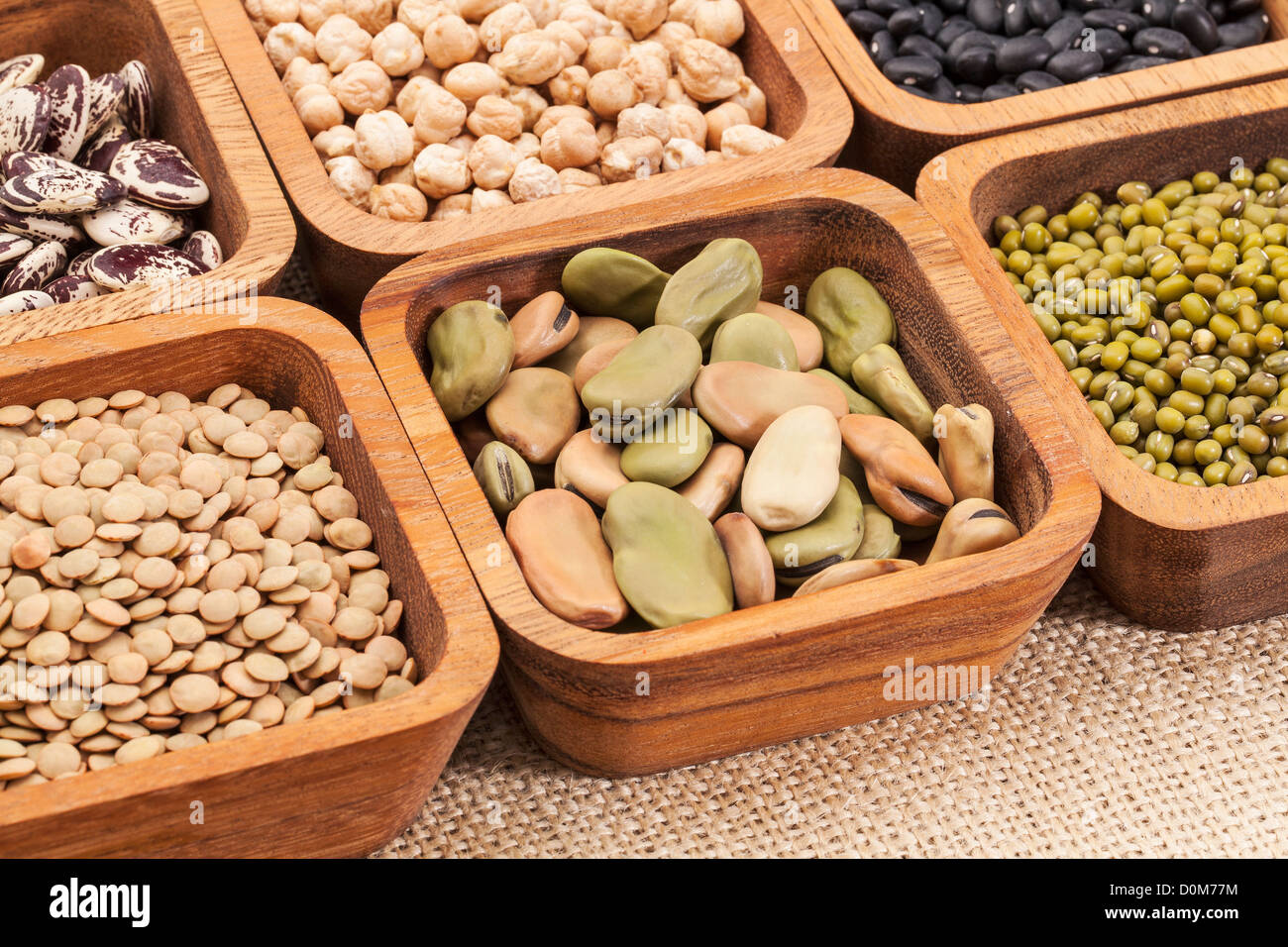 a collection of bean and lentil in wooden square bowls Stock Photo