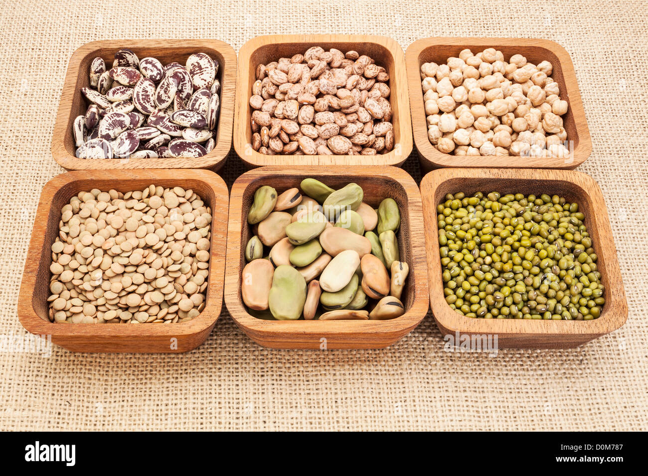 a collection of bean and lentil in wooden square bowls Stock Photo