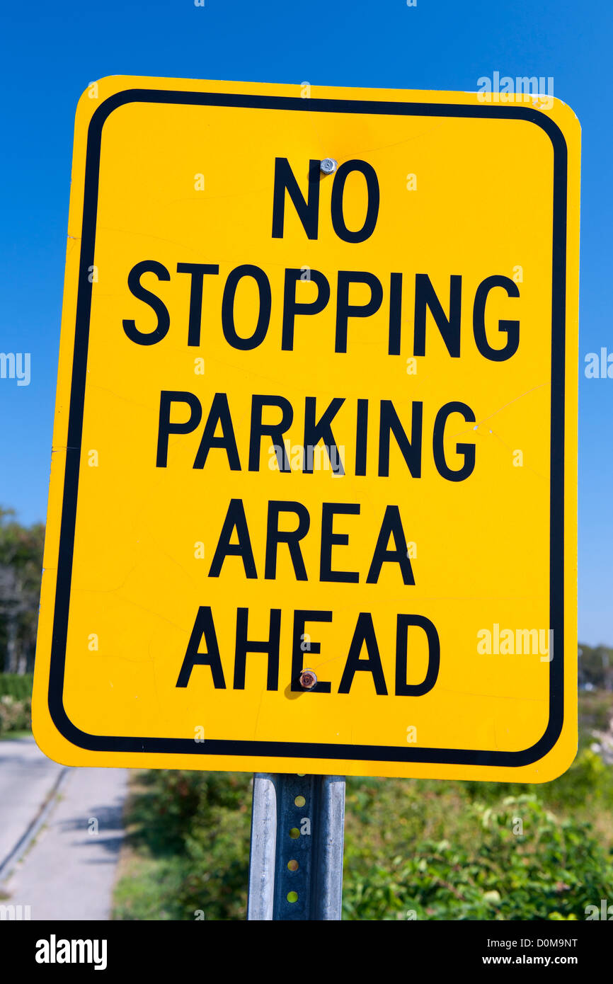 'No stopping parking area ahead ' traffic sign against a blue sky. Stock Photo