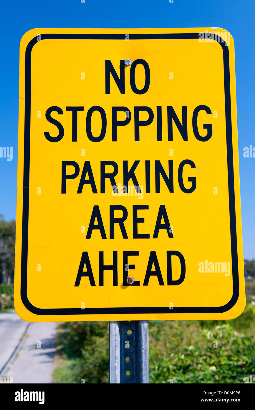 'No stopping parking area ahead ' traffic sign against a blue sky. Stock Photo