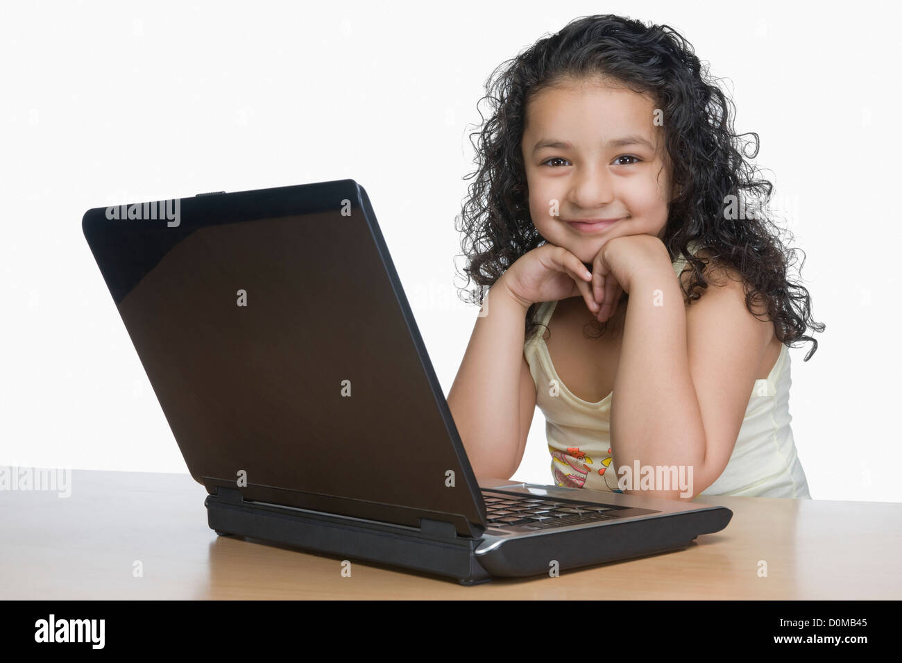Portrait of a girl smiling in front of a laptop Stock Photo - Alamy