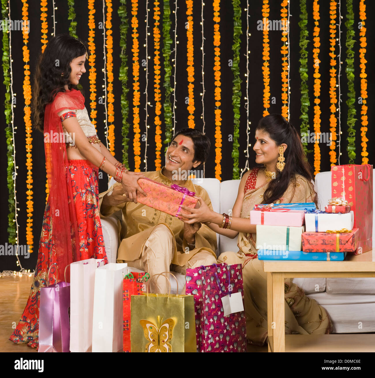 Couple giving gifts to their daughter on Diwali festival Stock Photo