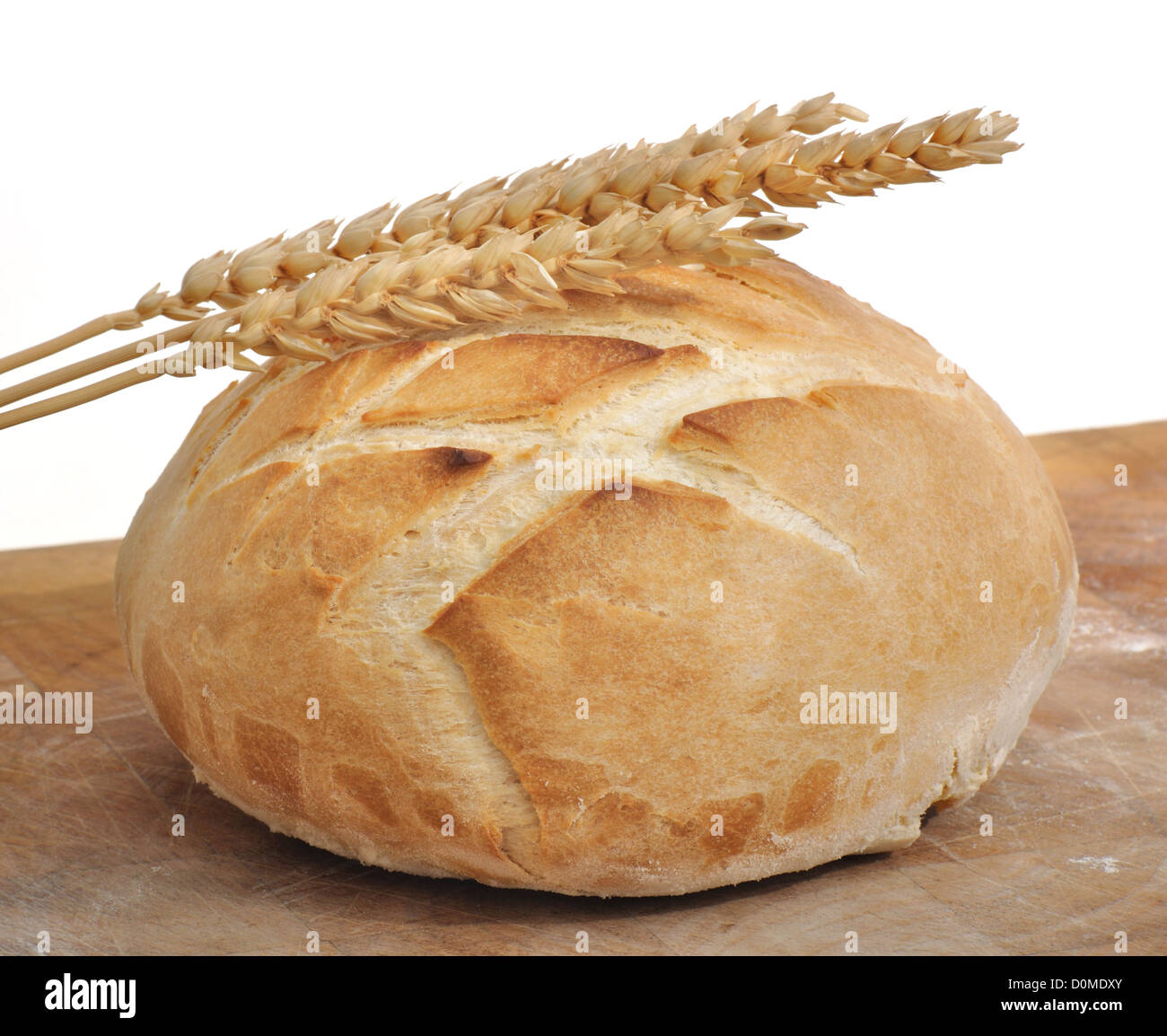 beautiful golden loaf of bread and wheat ears on white background ...