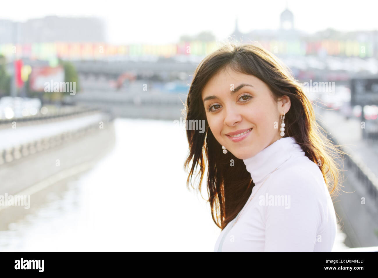 Smiling girl at city river Stock Photo - Alamy