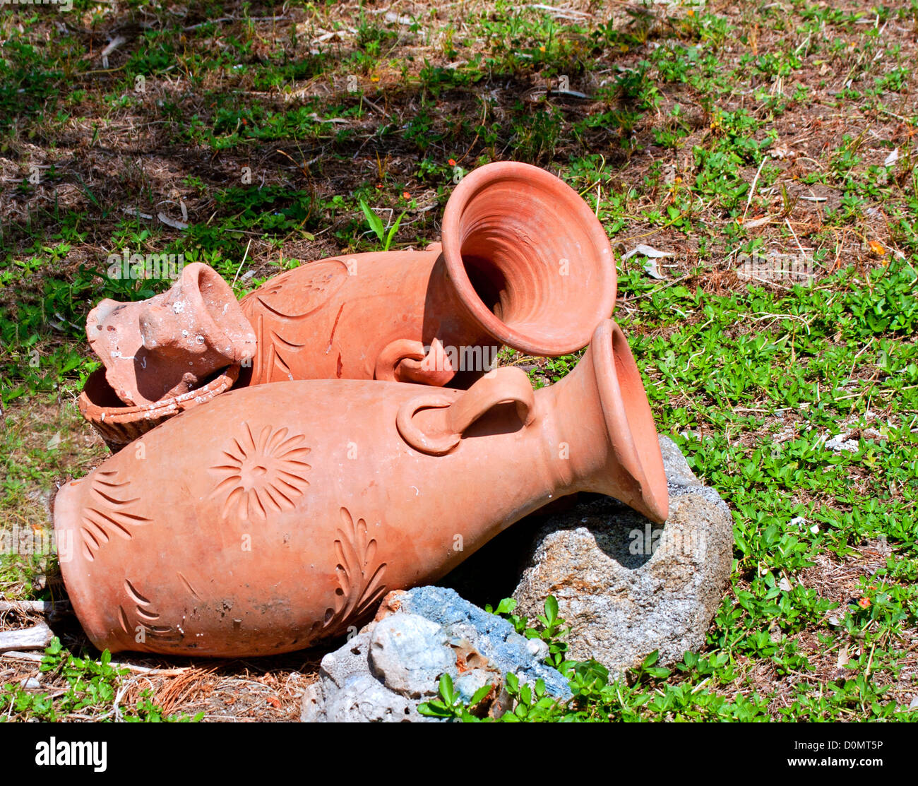 Greek amphoras lying on green grass Stock Photo