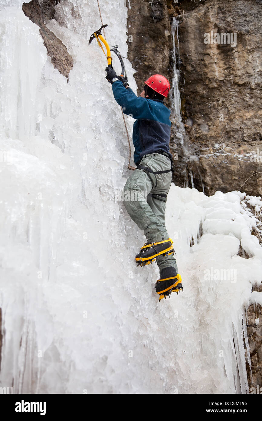 Man with ice axes and crampons Stock Photo