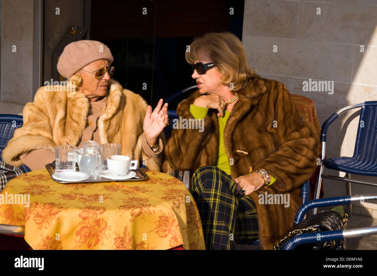 Rich expensively dressed older women in conversation Stock Photo - Alamy