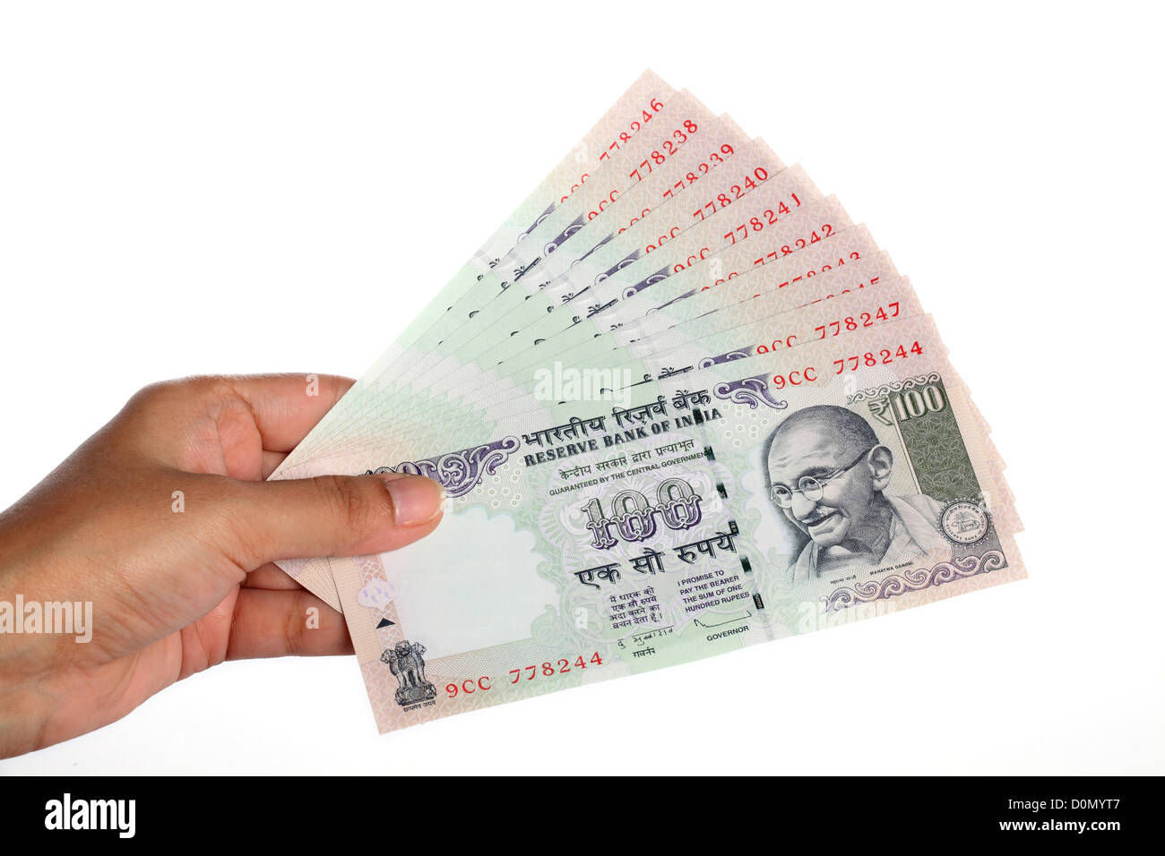 Hand with hundred Indian rupee notes on white background Stock Photo