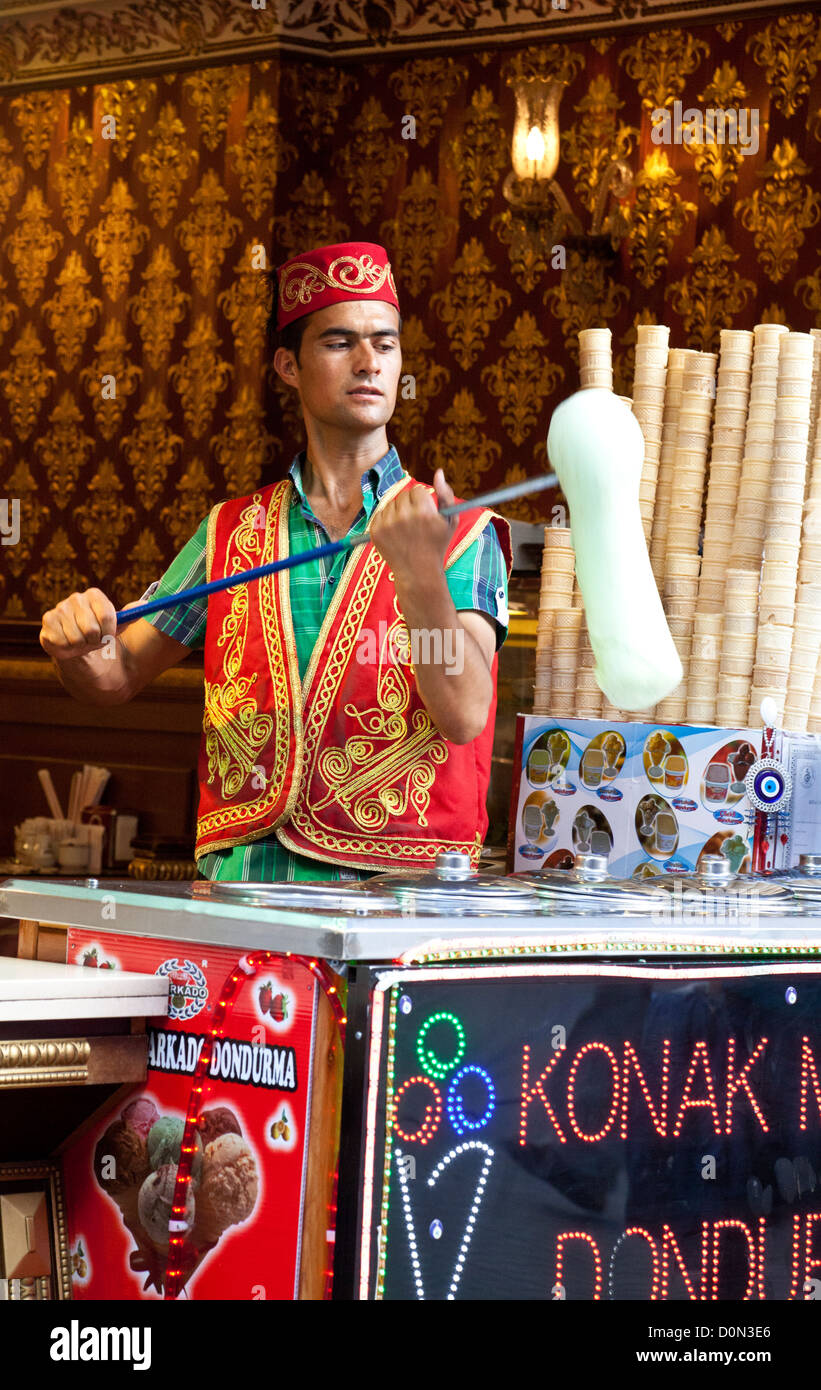 A vendor twirling Turkish dondurma ice cream for tourists in the Taksim district of Istanbul, Turkey Stock Photo