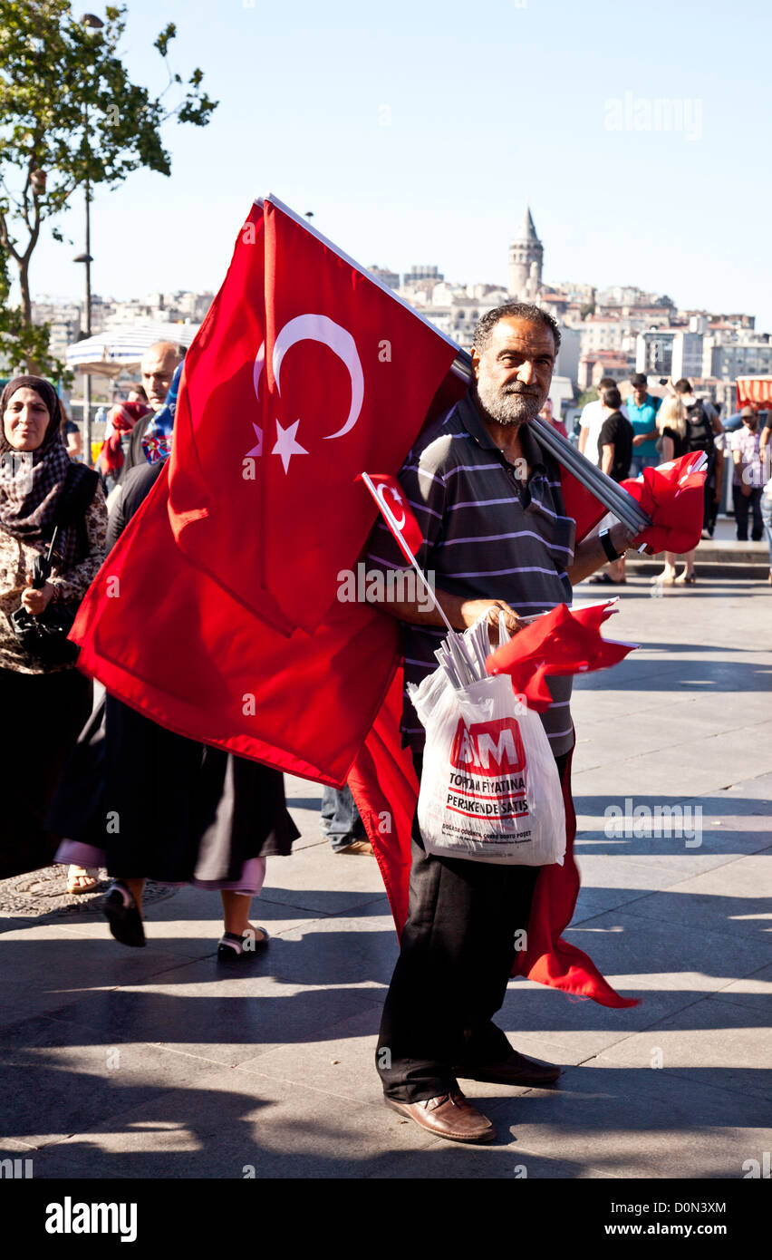 A man selling Turkist flags near the ports at Eminonu, Istanbul. Stock Photo