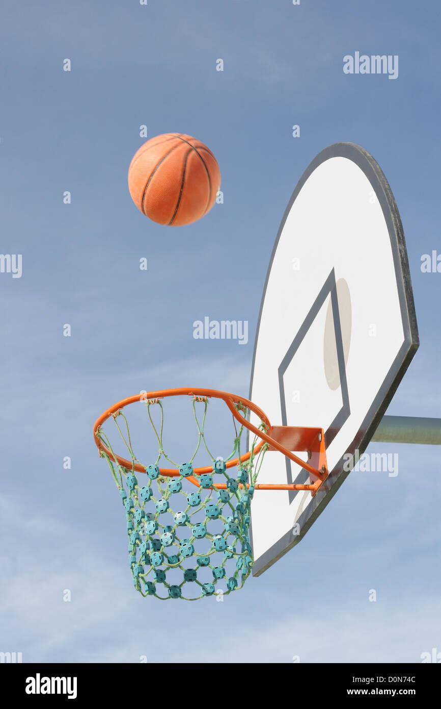 Basketball flying into hoop bucket Stock Photo Alamy